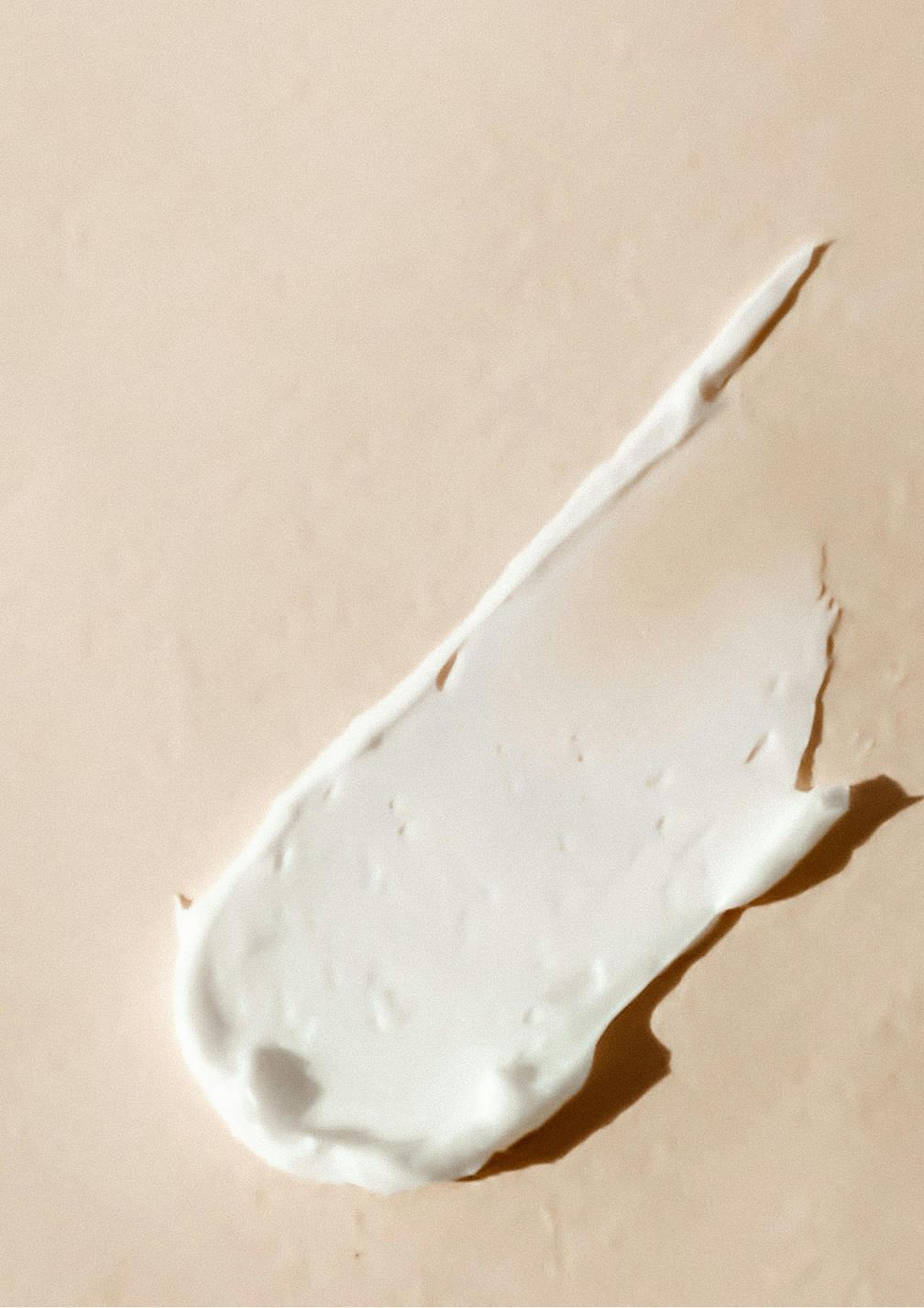 A smear of makeup cream on an adobe surface