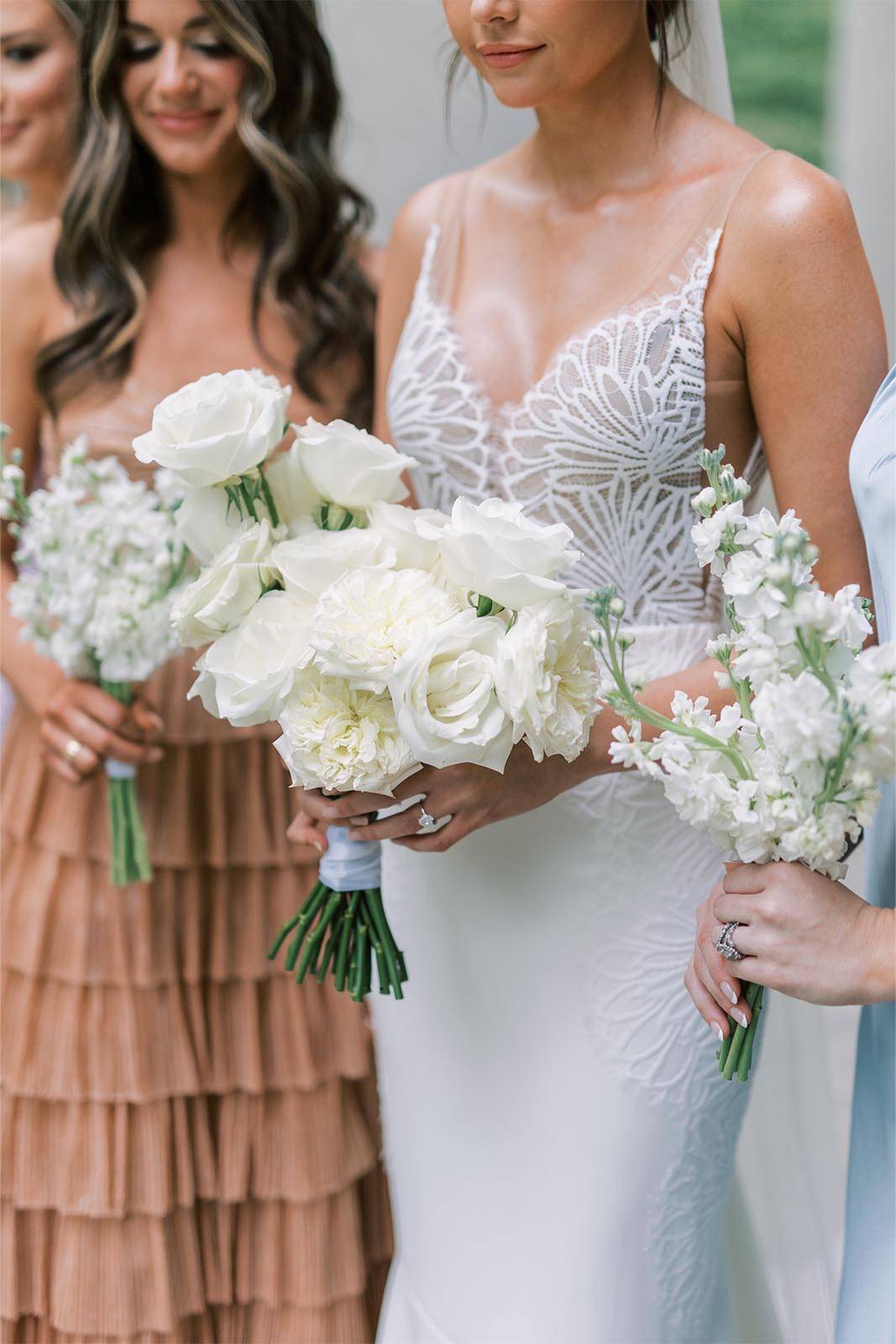 Close up shot of the bride and her bridesmaids, showcasing their beautiful attire and flower arrangements,