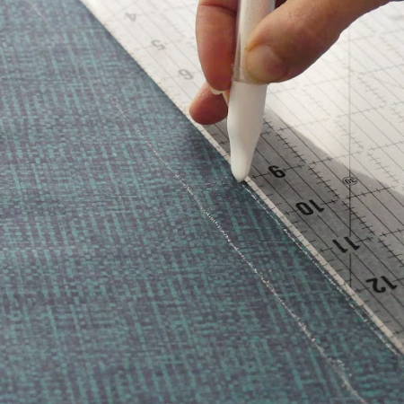 Marking fabric with a ruler and a white chalk marker