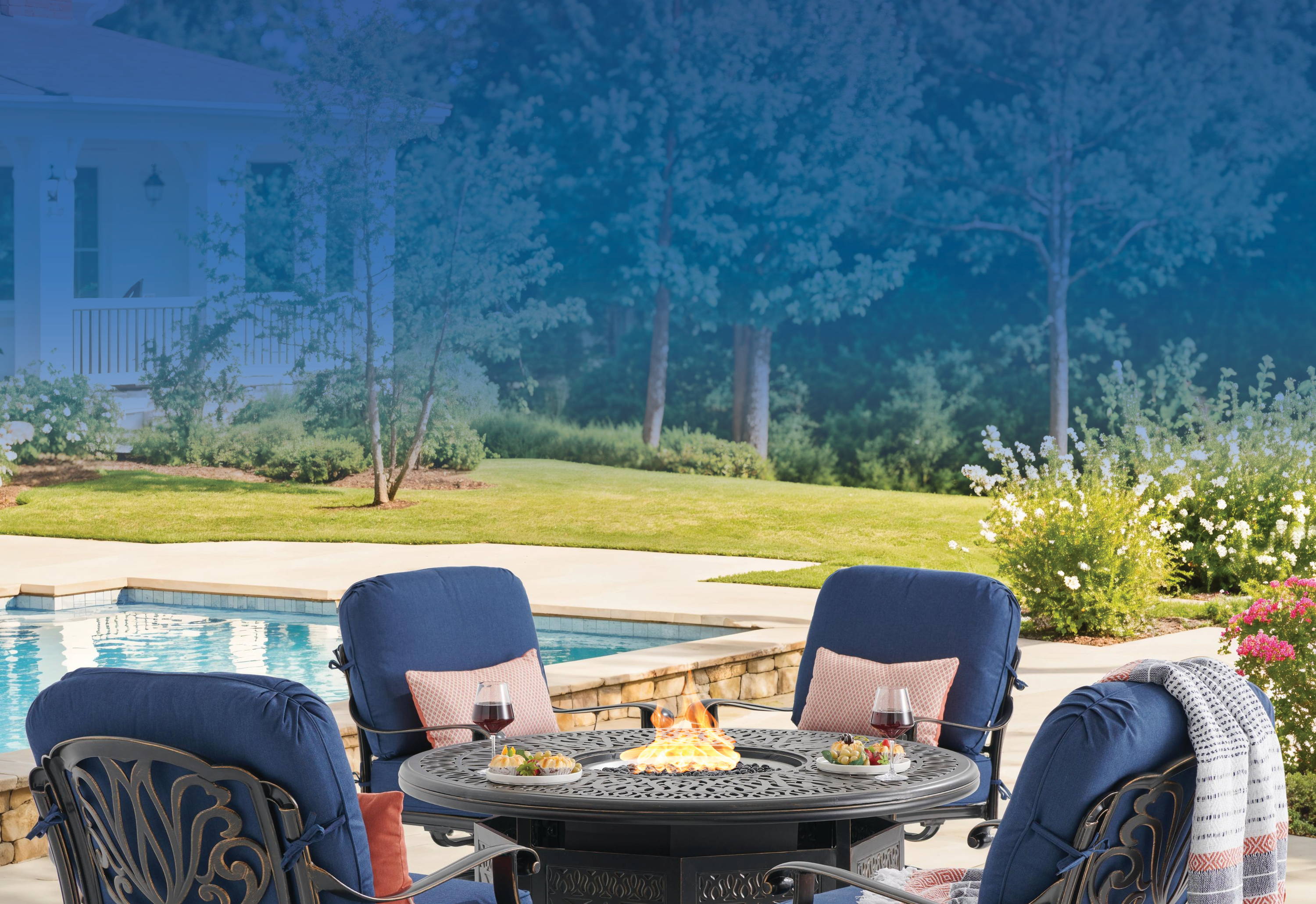 Patio seating area with four chairs and a fire pit.