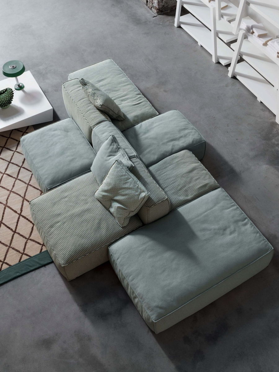 Aerial view of a modern gray Peanut Sofa sectional sofa in grey by Bonaldo and coffee table.