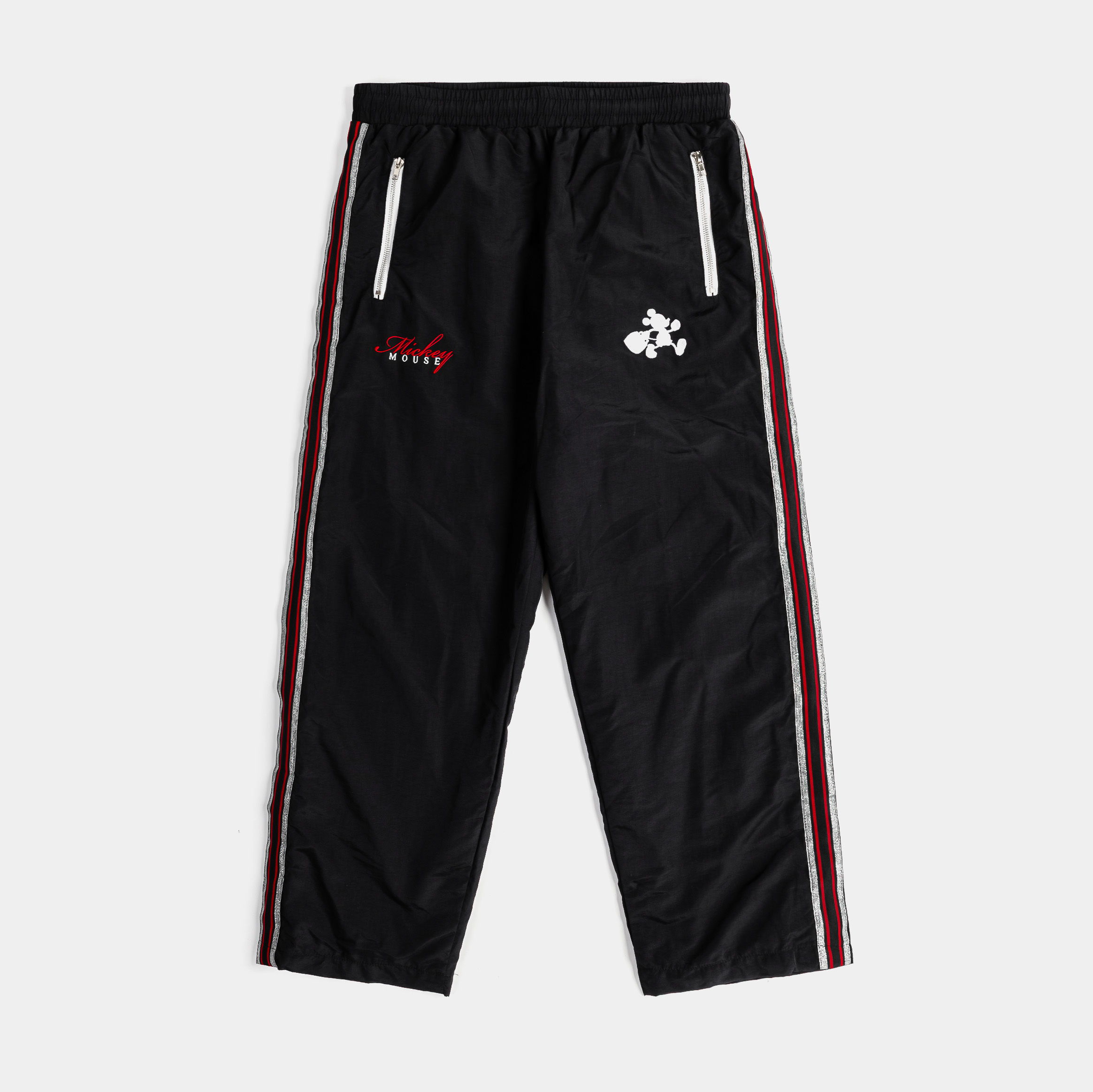 Black athletic pants with red and white side stripes and logo.