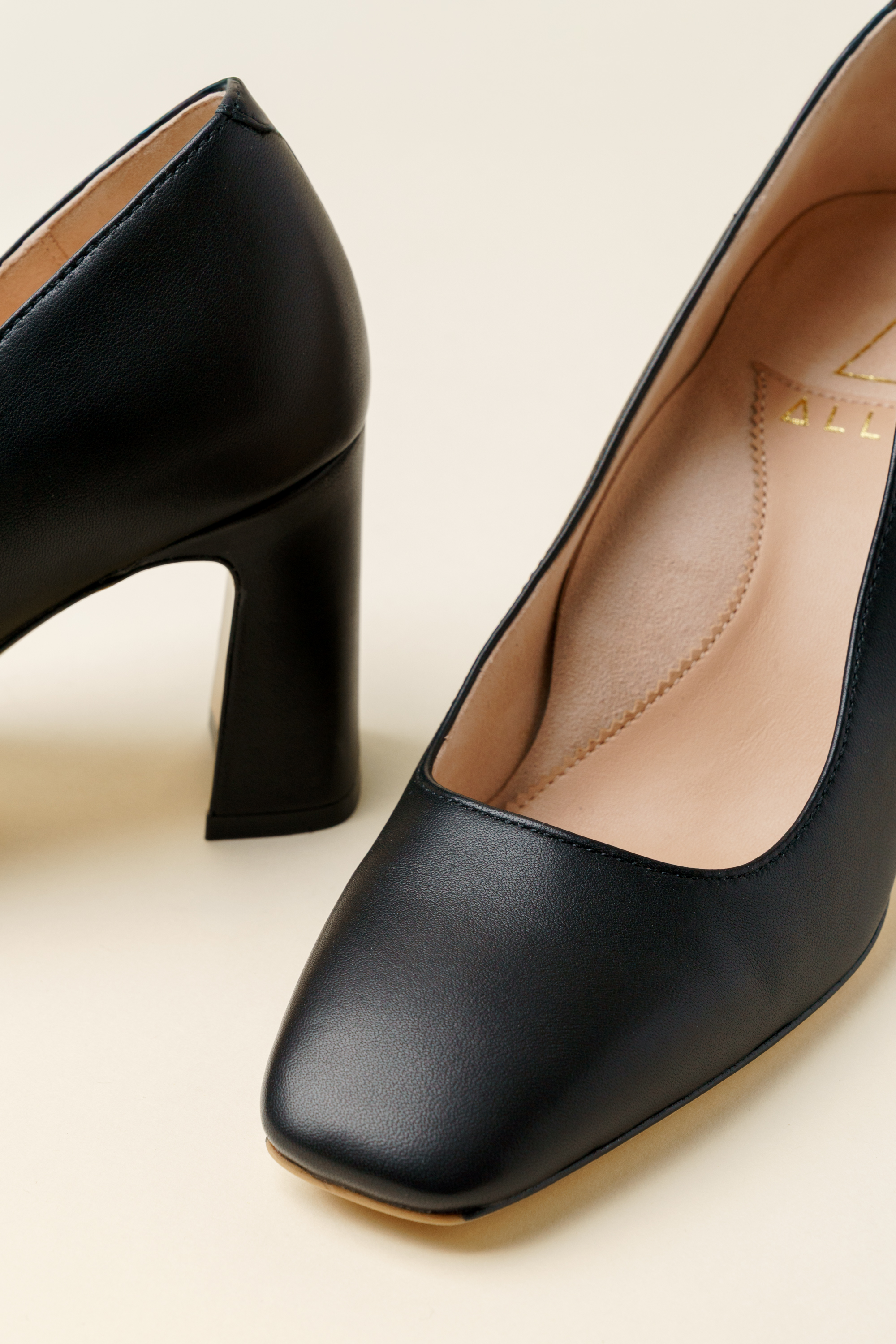 A pair of black leather high-heeled shoes.