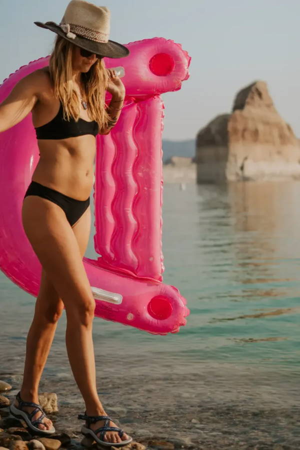 woman walking on beach with water sandals