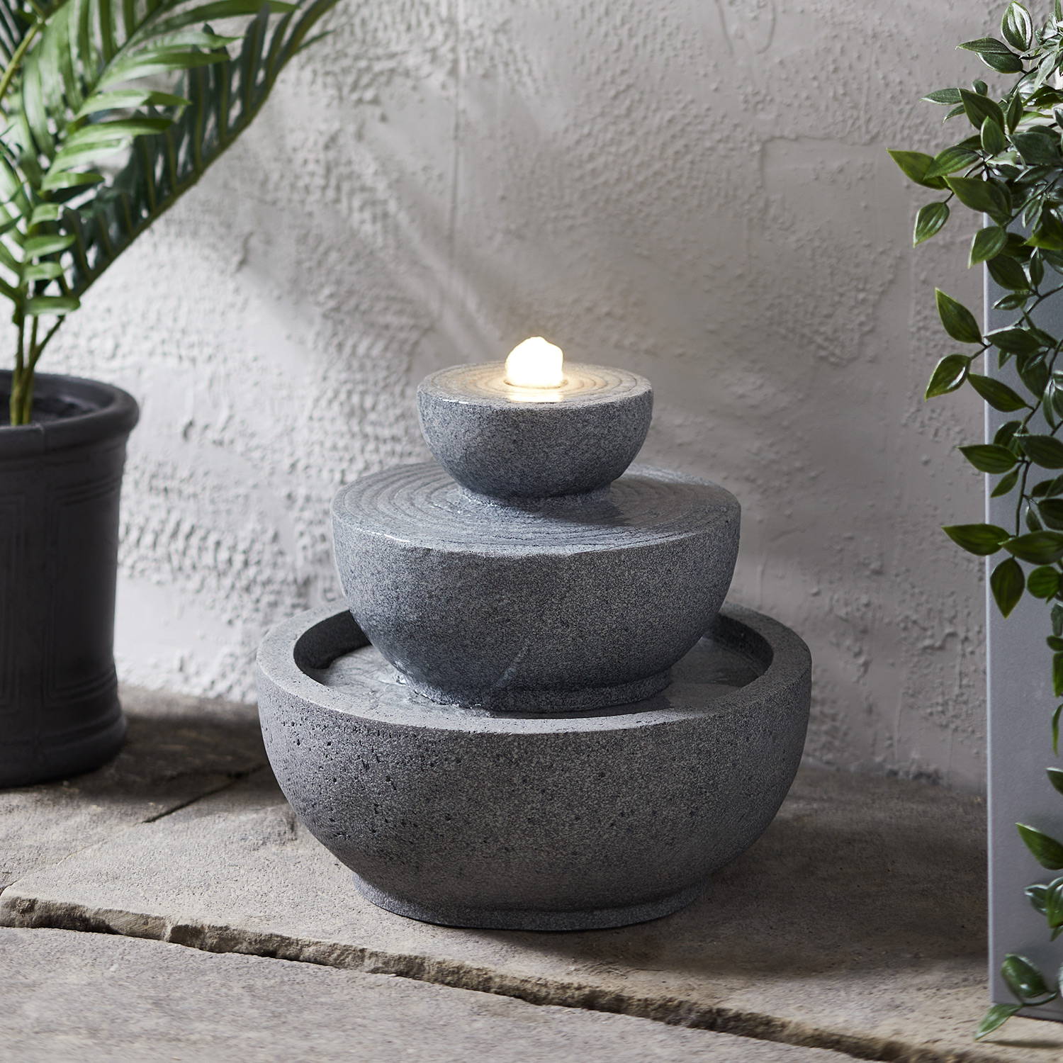 Grey stacked water feature illuminated and switched on