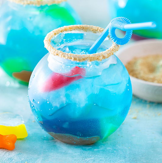 Blue Raspberry Fish Bowl Mocktails with a blue straw - see more on our Instagram