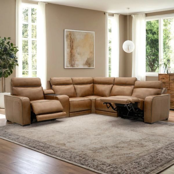 Tan moto motion sectional sofa in a bright, modern living room with large windows.