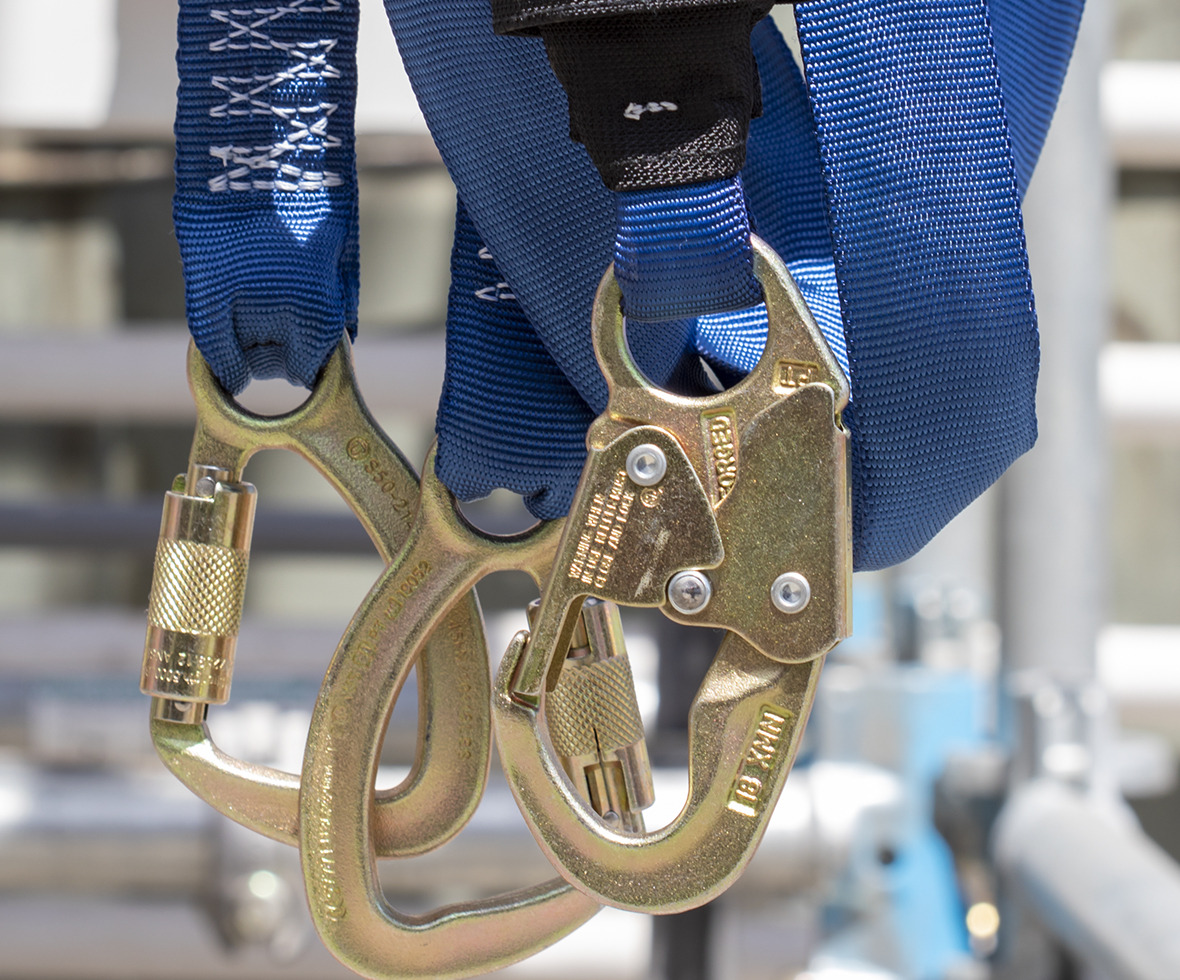 Twin leg specialty application energy absorbing lanyard hanging from scaffolding
