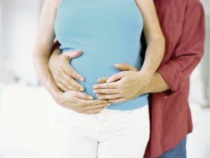 Couple Holding Pregnant Stomach