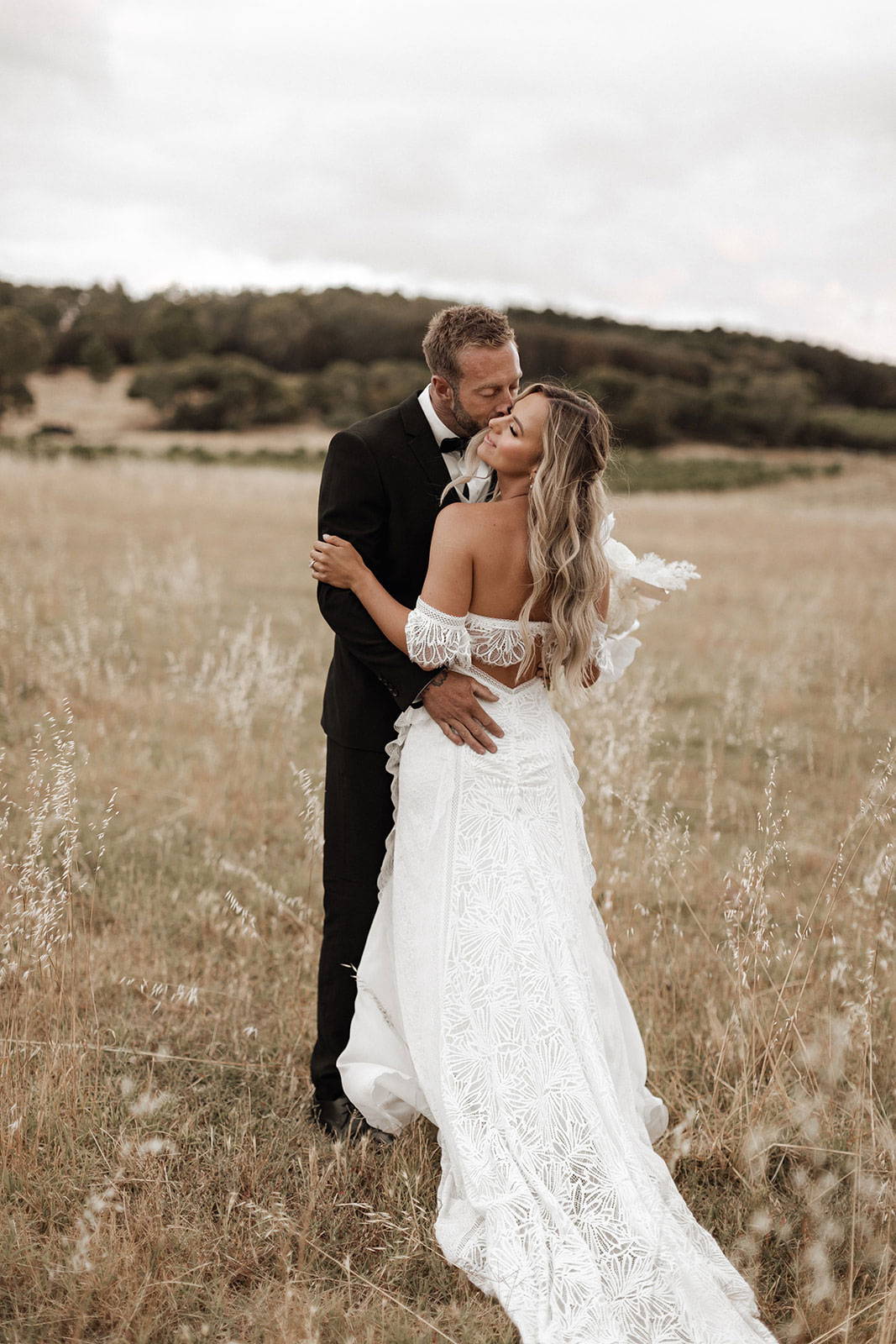 Bride and groom in country field