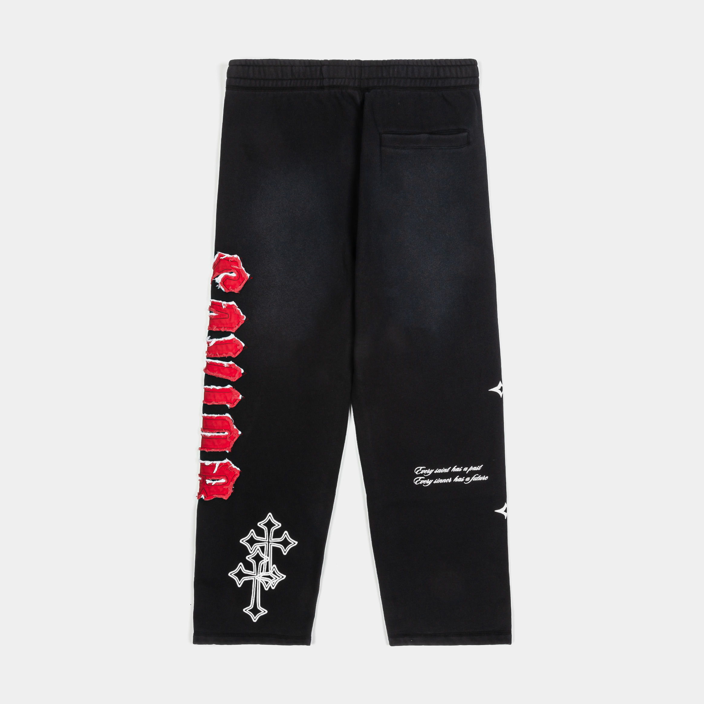 Black pants with white crosses and red text graphics.