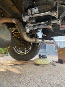 Four chrome train horns installed on the rear undercarriage of Malachi's Ford F250 during installation