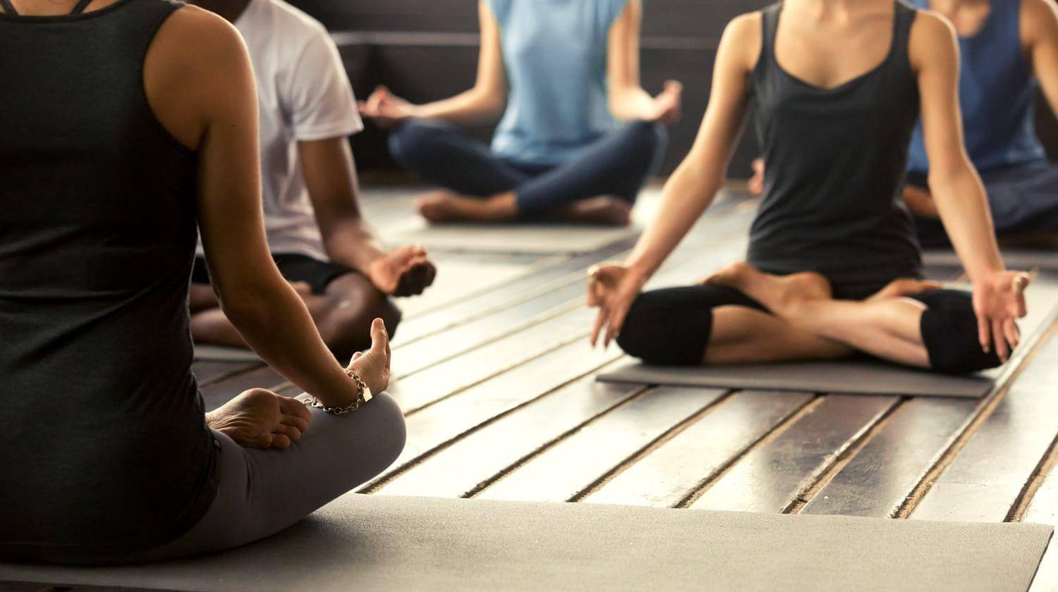 Featured | Group of young sporty people practicing yoga lesson with instructor | Detox Your Body With These Top Yoga Routines and Stretches