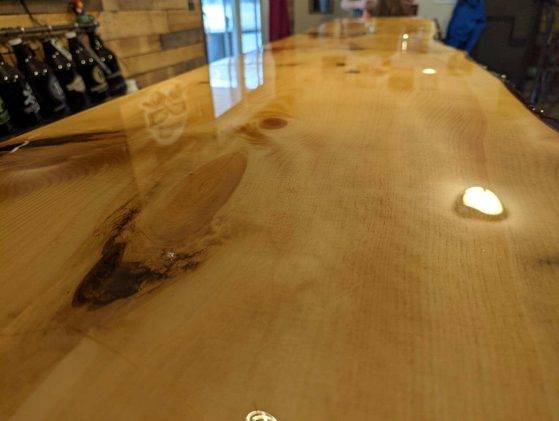 An alternate view of a live-edge wooden epoxy bar top.