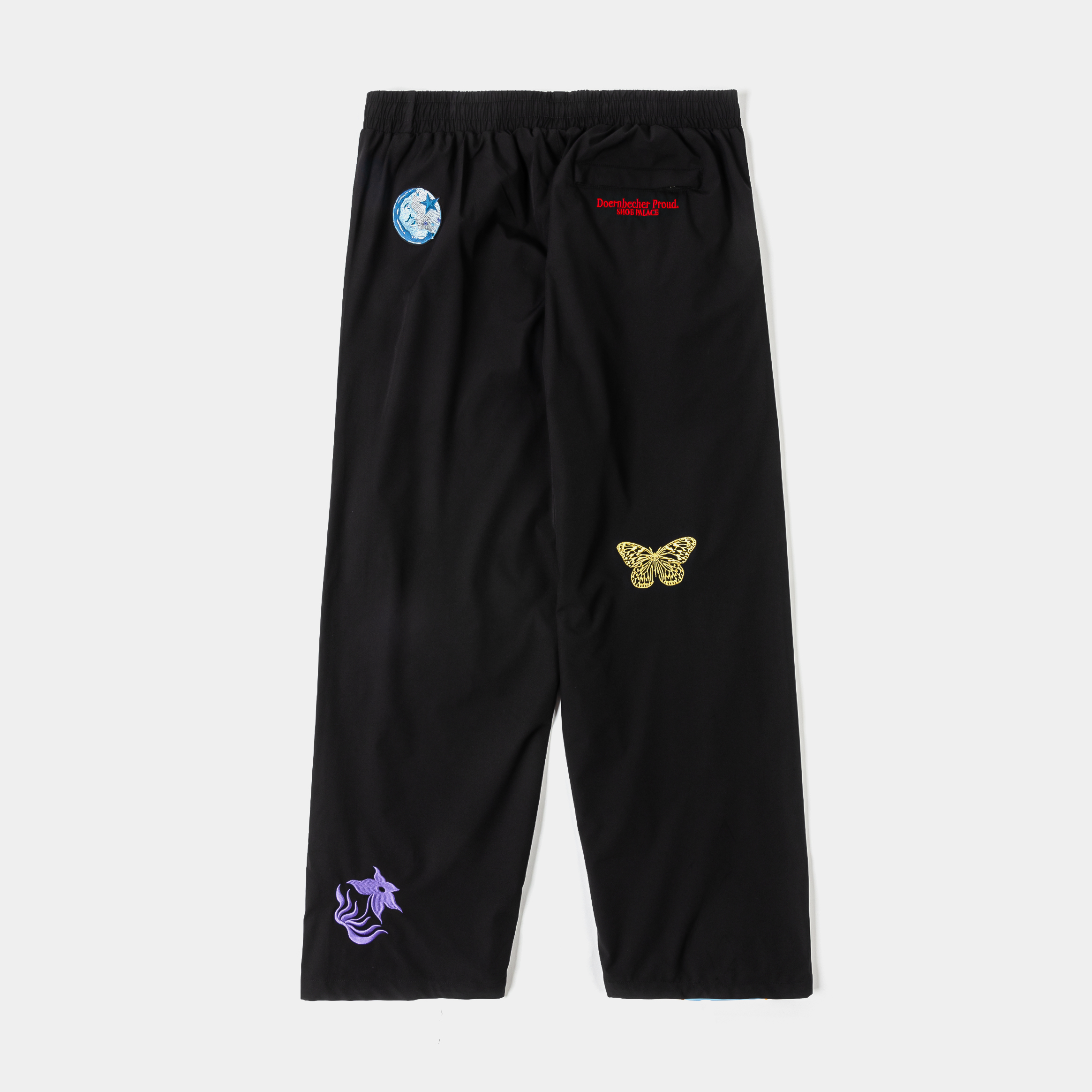 Black athletic pants with red and green accents and blue side stripes.