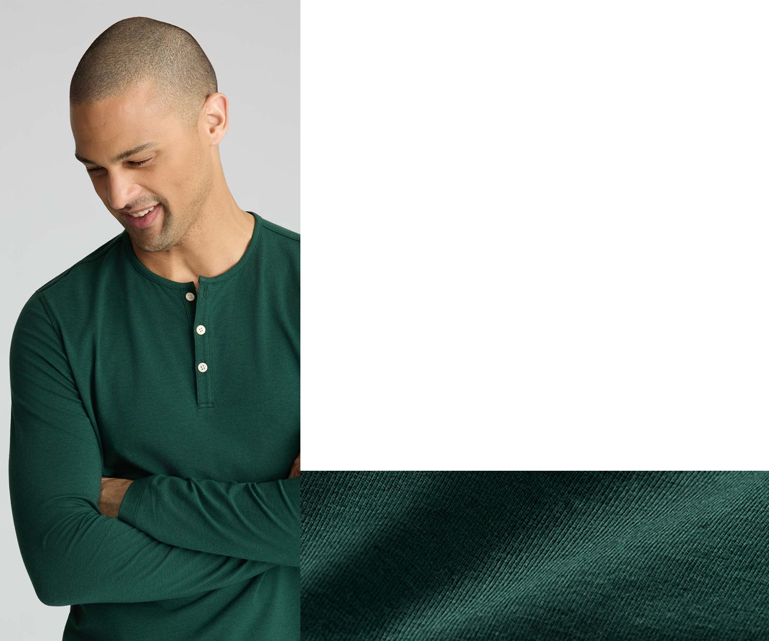 Man in green long-sleeve shirt looking down, smiling slightly.