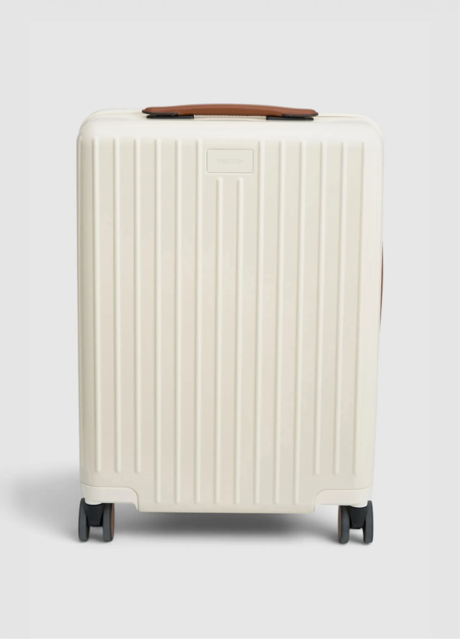 White suitcase with a textured surface and brown handle, on wheels.