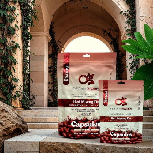 Two packages of red maca capsules displayed in a decorative setting.