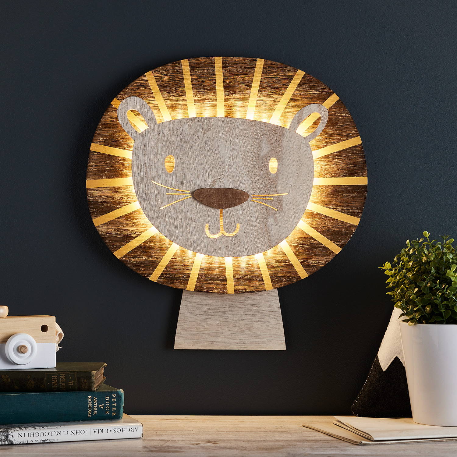 Lion wall light illuminated on wall