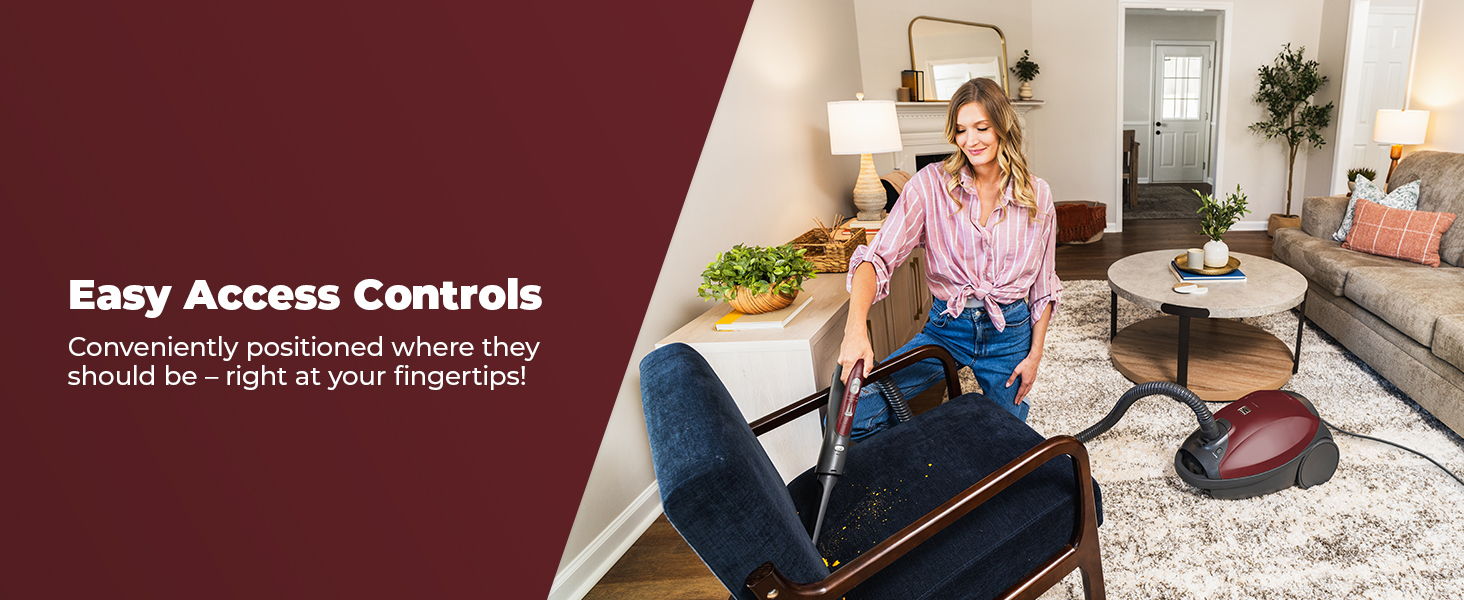 Woman using a vacuum cleaner in a cozy living room setting.