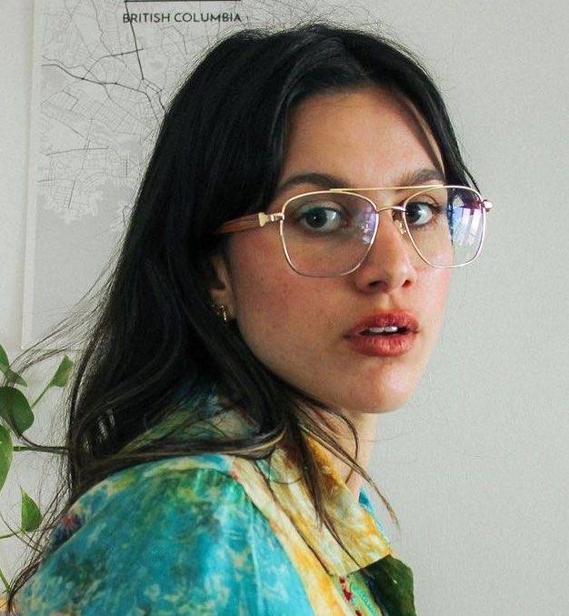 Woman with round face shape wearing Drive Gold, Retro Square Eyeglasses in Gold Metal with a printed shirt