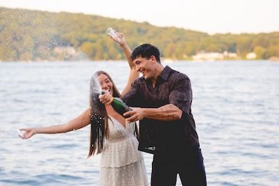 engaged couple celebrating with champage, candlewood lake