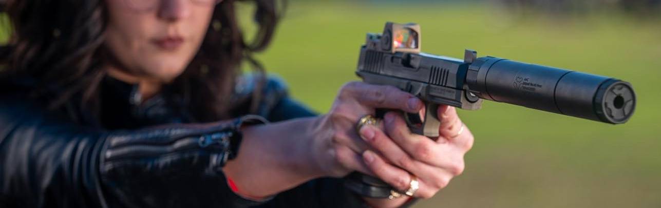 Woman Shooting Firearm With AAC Silencer