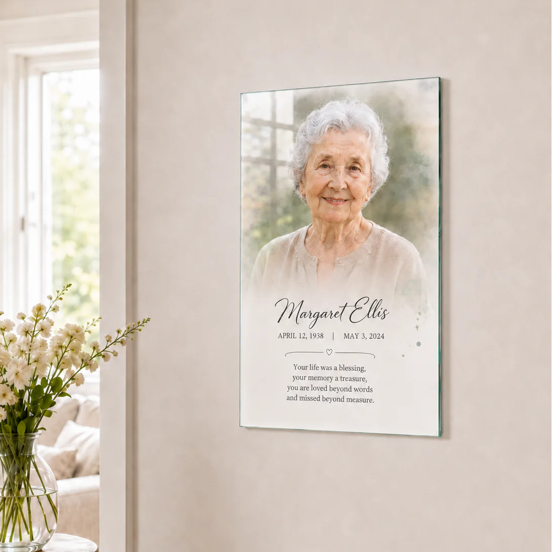 Portrait of an elderly woman on a wall with floral decor nearby.