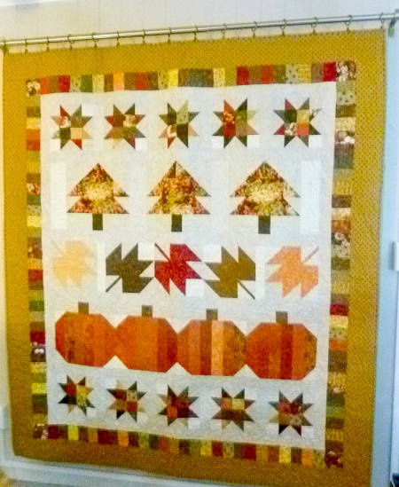 Seasonal quilt that hangs with quilt hangers