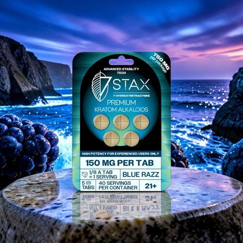 A package of Stax premium gummies on a rocky surface by the ocean.