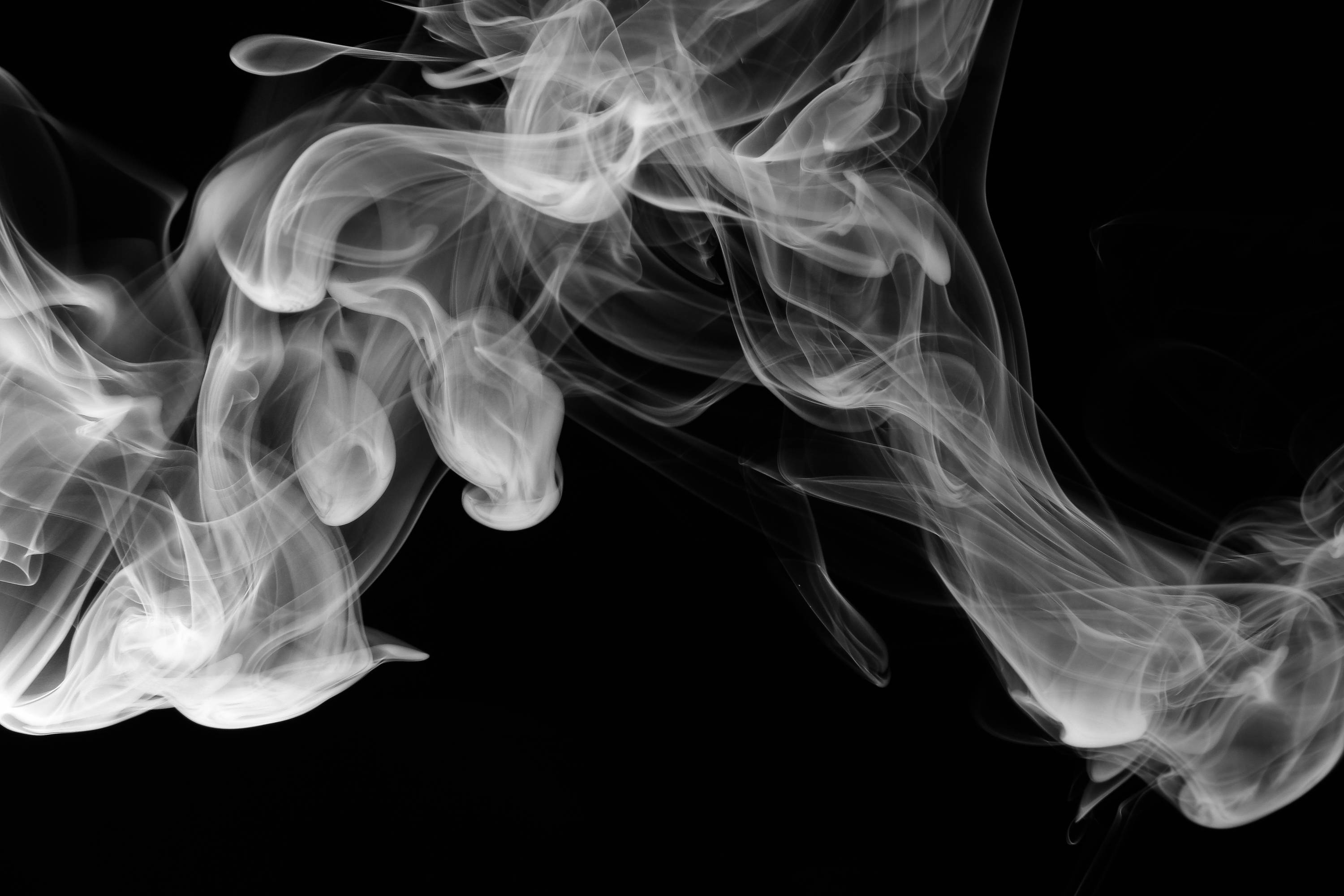 Smoke from a vape cart against black background