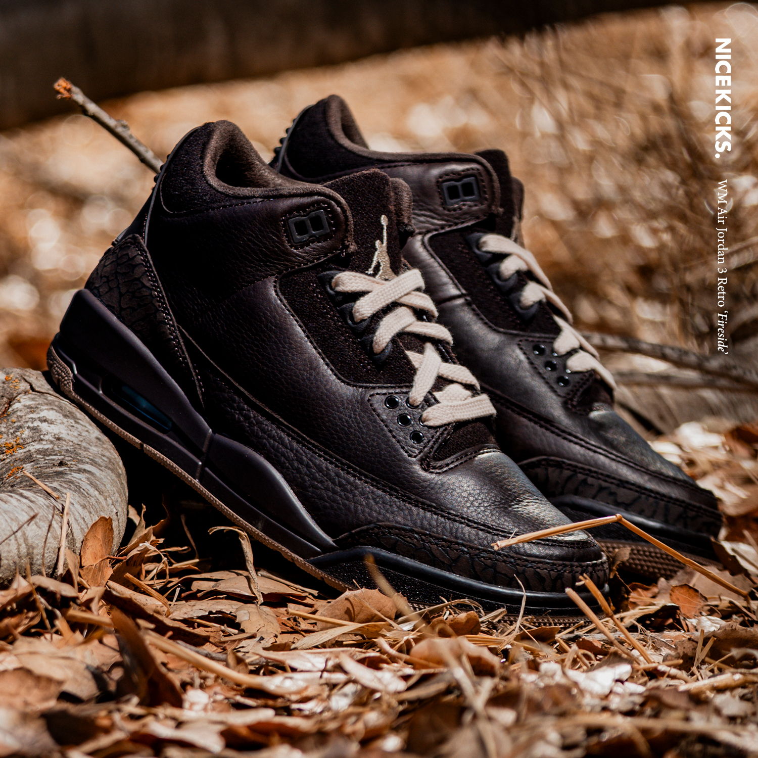 A pair of black sneakers on a bed of leaves.