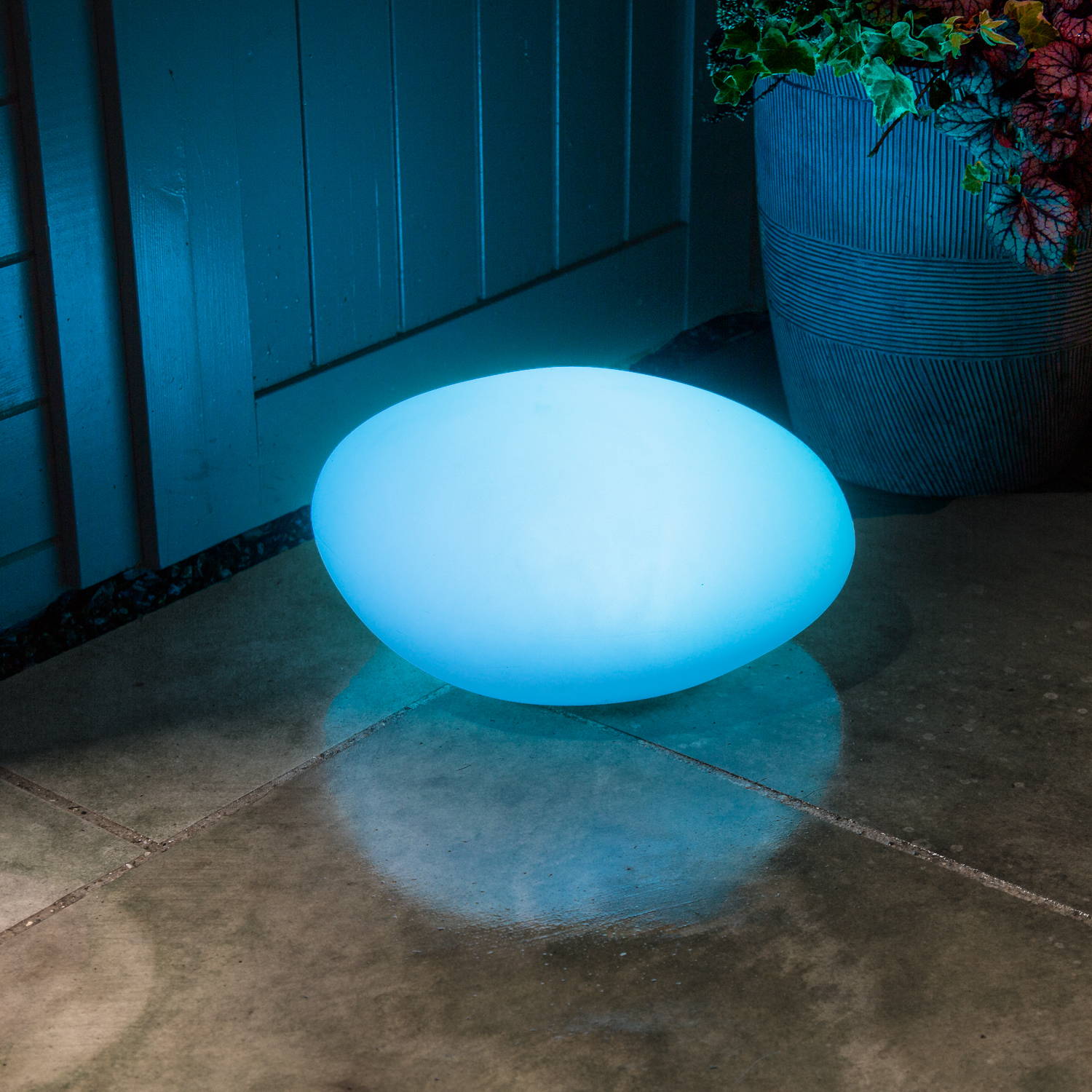 Blue solar pebble light outdoors