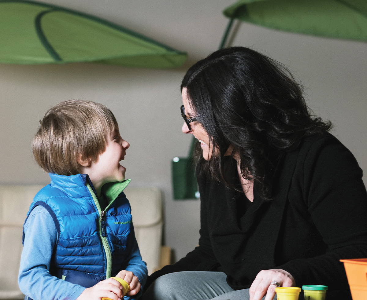Speech-Language Therapist assessing a young communicator in need of AAC