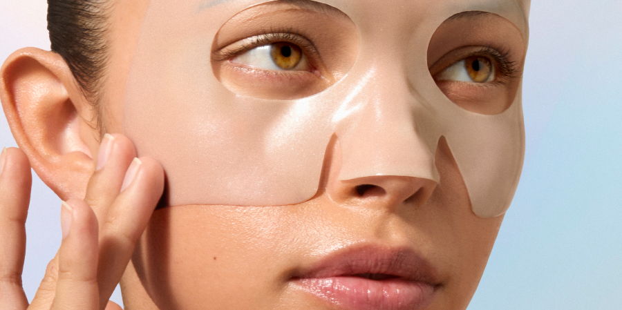 Person applying a facial mask to their skin.