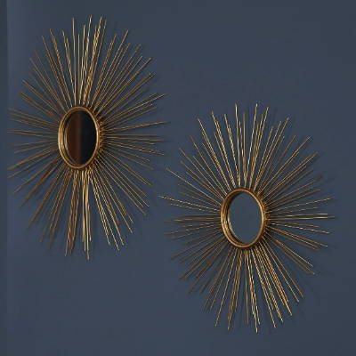 A pair of accent wall mirrors shaped like the sun