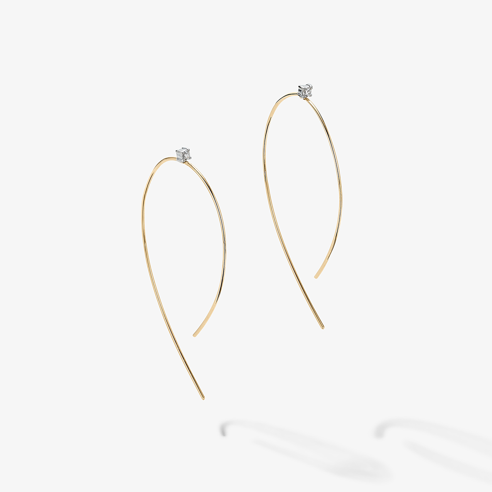 Gold hoop earrings with small diamond studs.