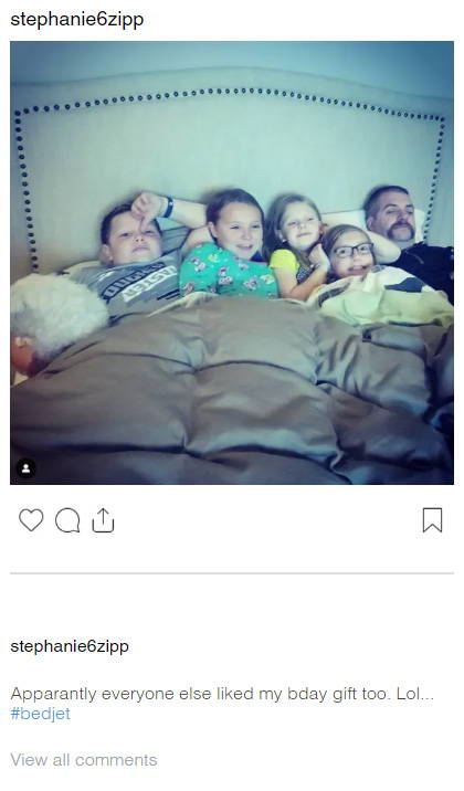 An Instagram post by @stephanie6zipp showing a father laying in bed with 4 children, all enjoying the BedJet airflow