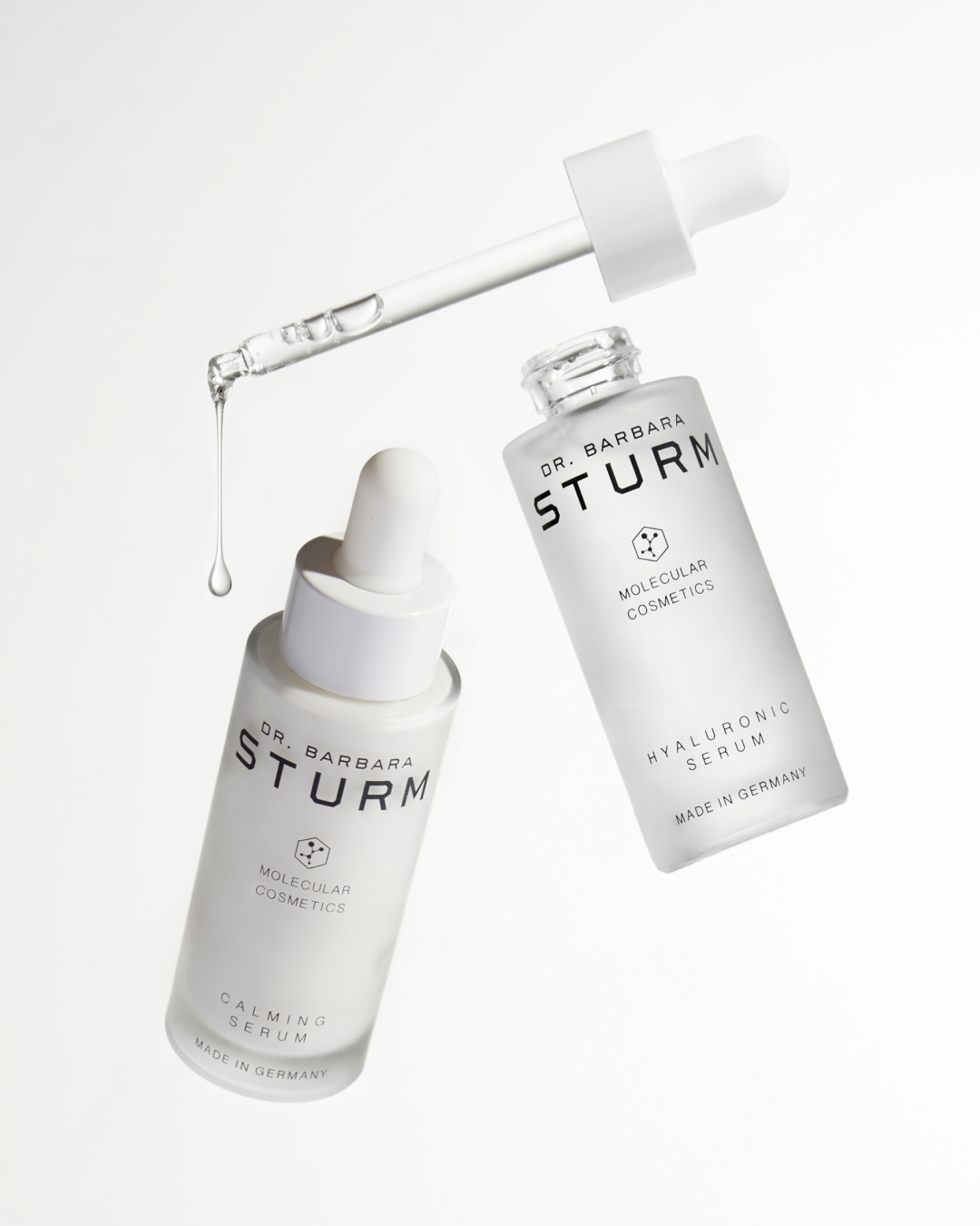 Two bottles of skincare serum with a dropper.