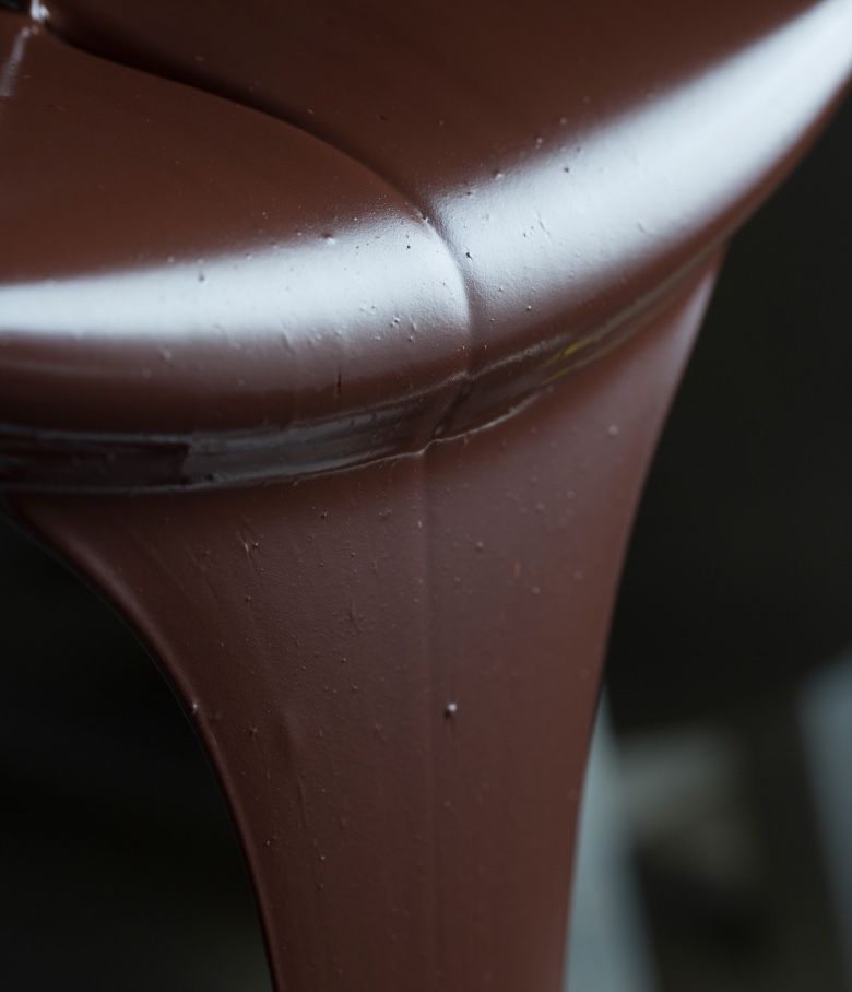 Close-up of thick, flowing chocolate in a container.