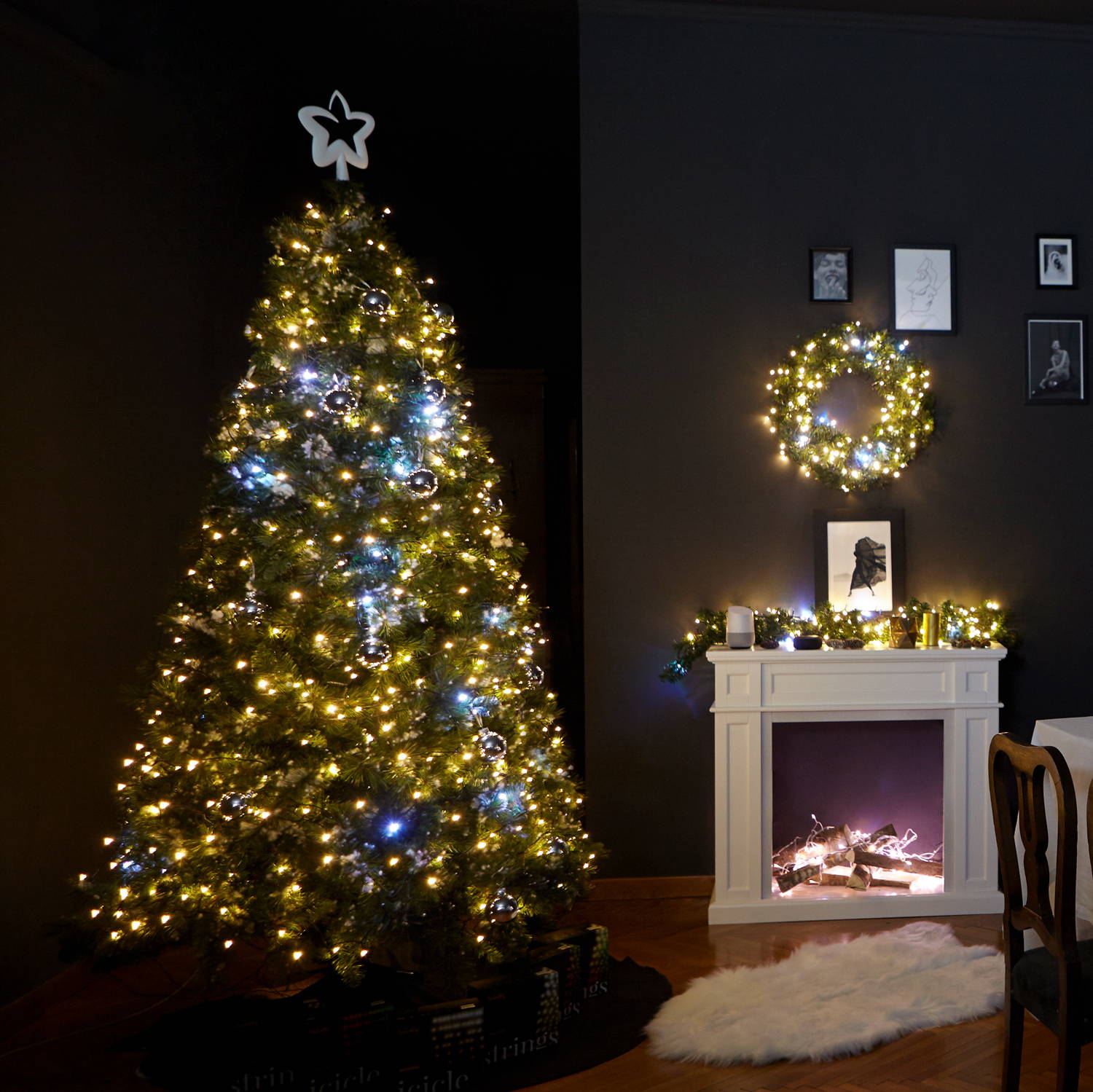 Gold edition Twinkly string lighting adorning Christmas tree, wreath and garland in living room