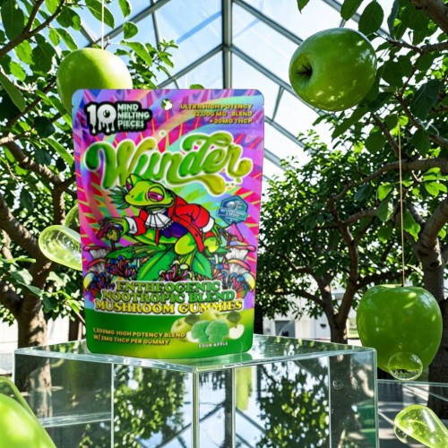 Colorful candy packaging in a greenhouse with green apples.
