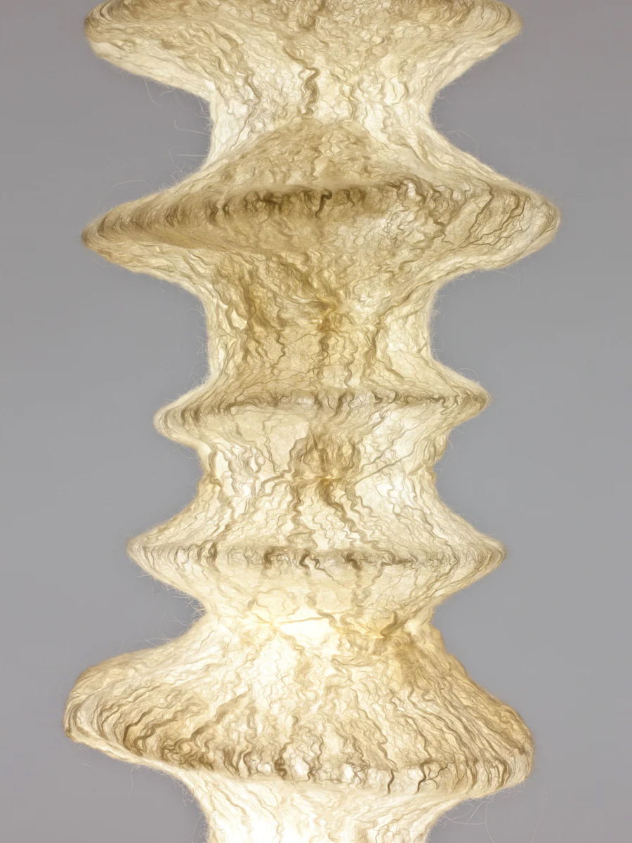 Textured sculpture with a wavy, layered design in white.