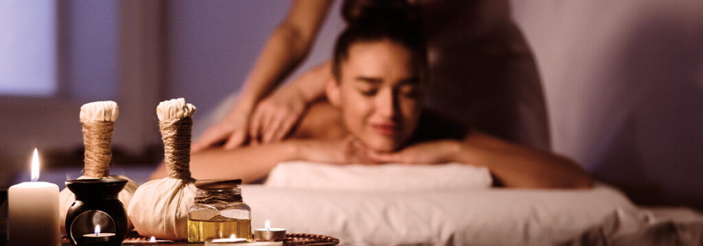 Person receiving a massage in a relaxing spa setting.