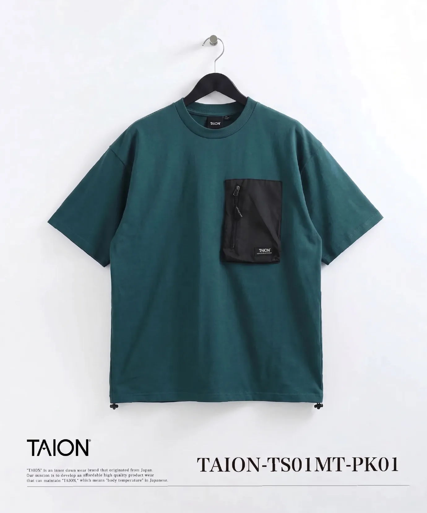 Green t-shirt with black pocket, hanging on a hook.