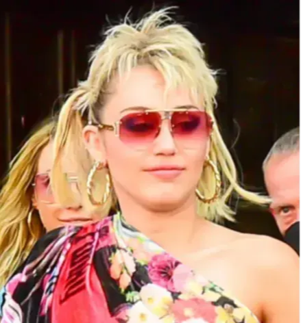 Miley Cyrus portant des lunettes de soleil aviateur teintées roses