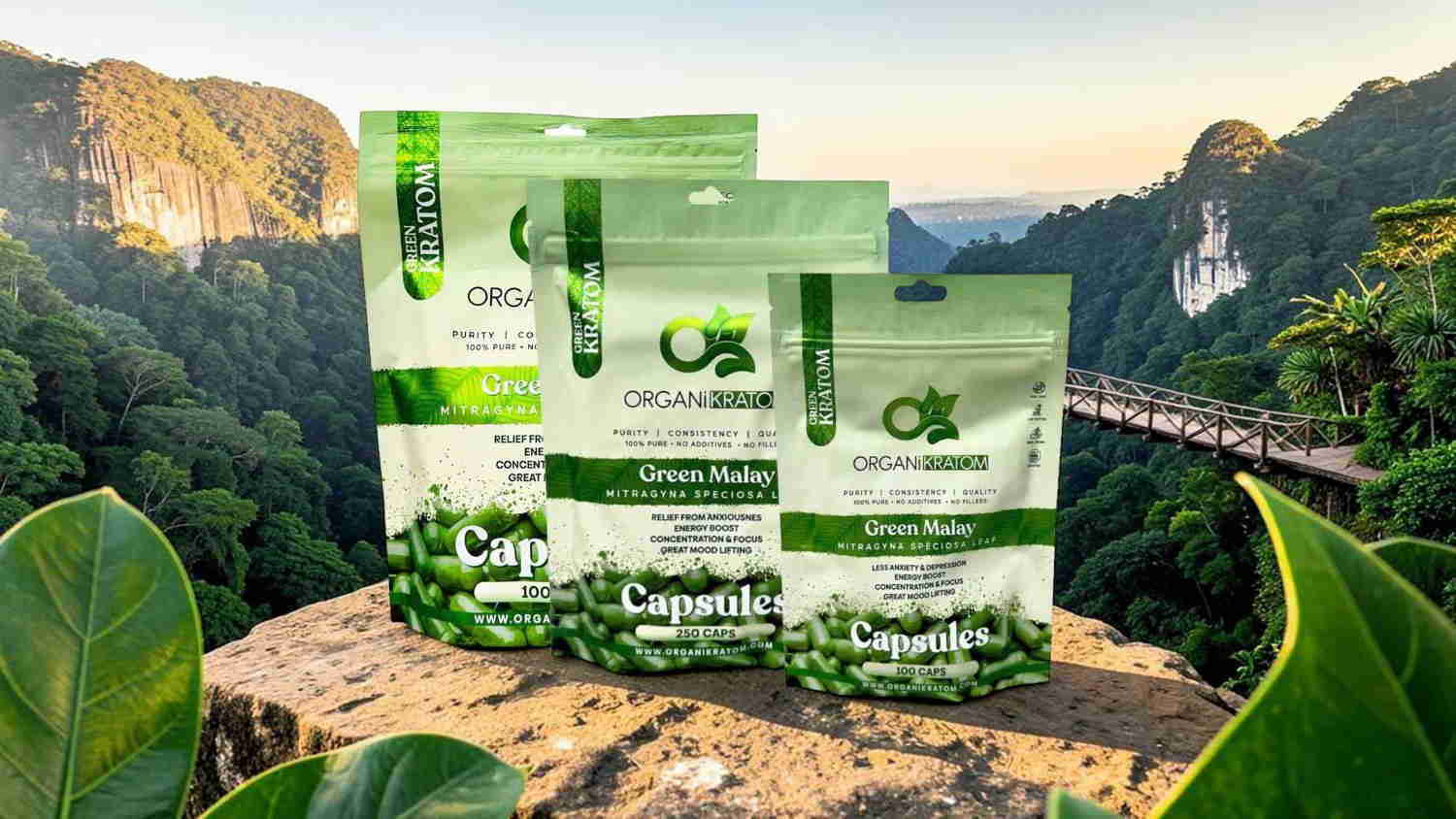 Three packages of green product on a stone with a scenic background.
