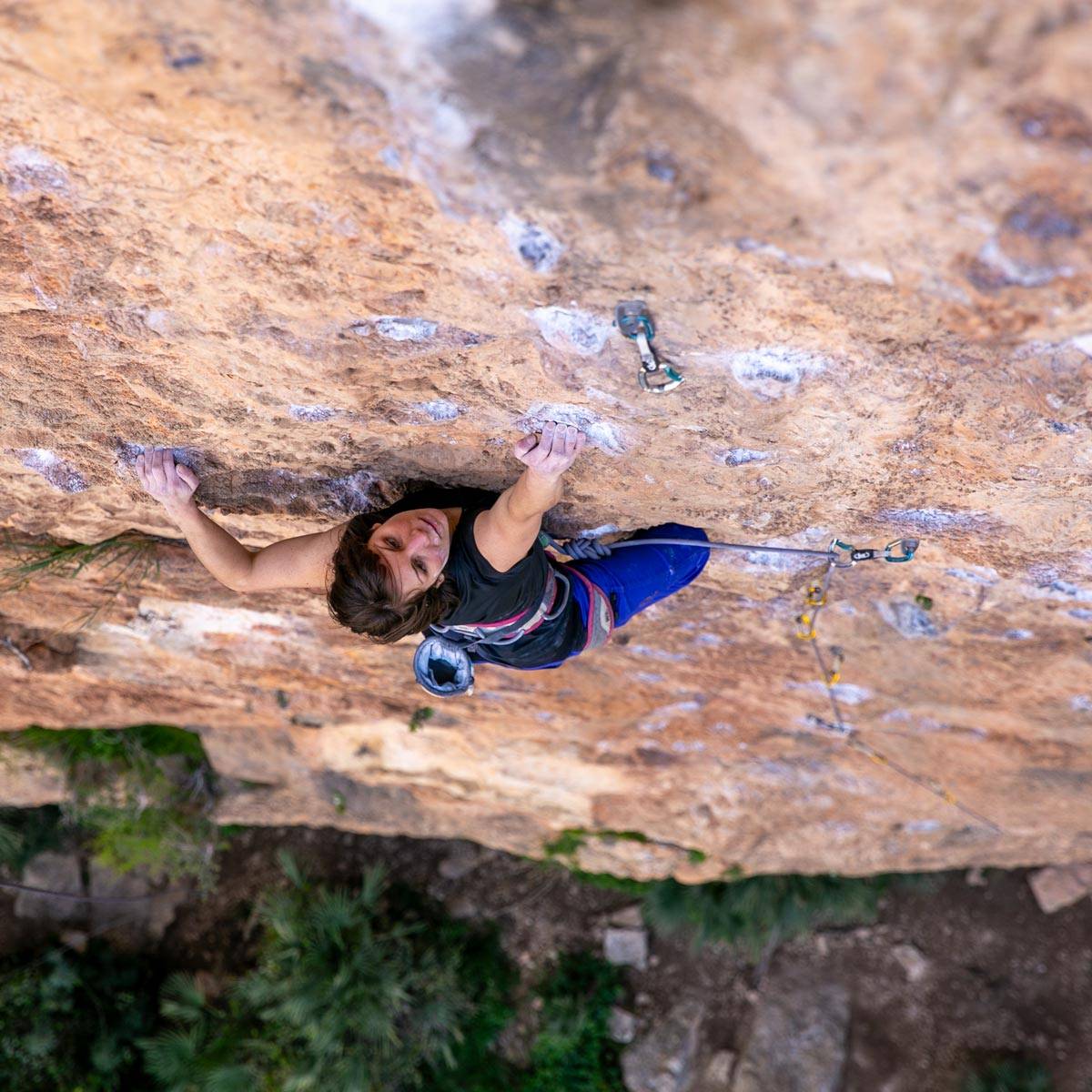 Alice Hafer climbing a chalk-smeared route in Chullia, Spain
