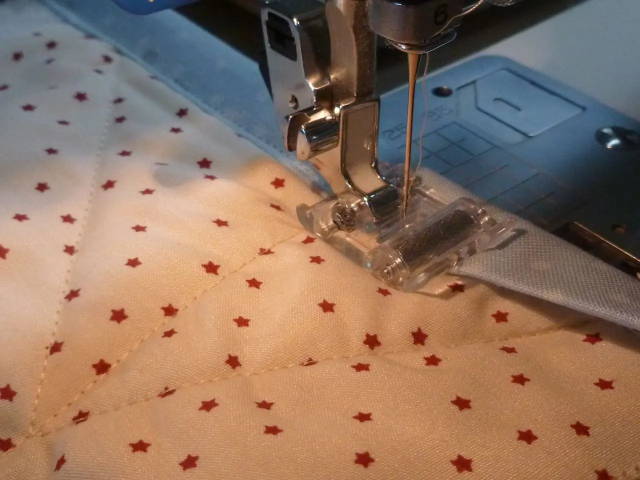 Attaching quilt binding with a roller presser foot