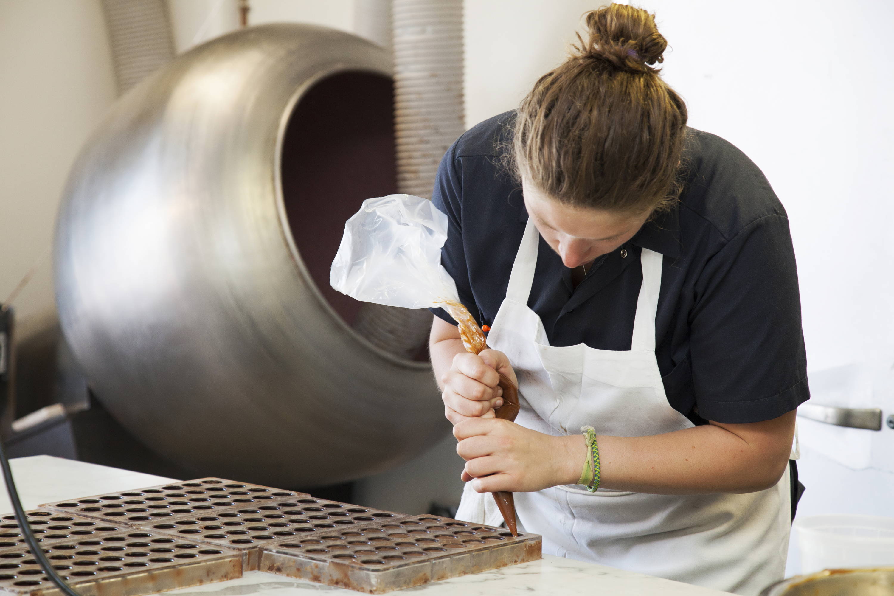 Feve worked pouring chocolate